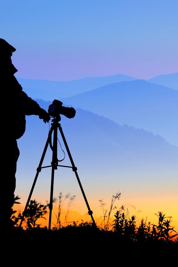 Silhouette of a landscape photographer in twilight